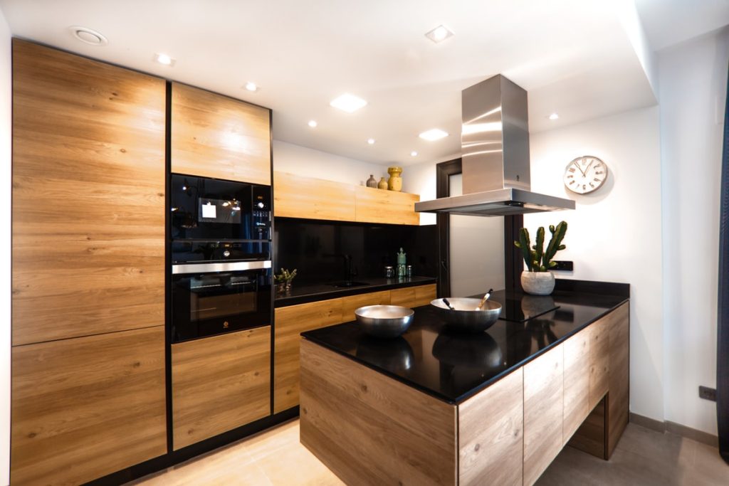 natural wood color cabinets with black countertops