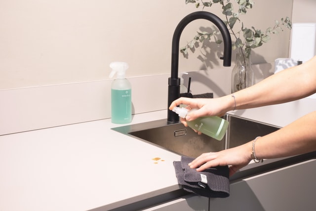 Wipe the sinks and surfaces to make home ready for guests