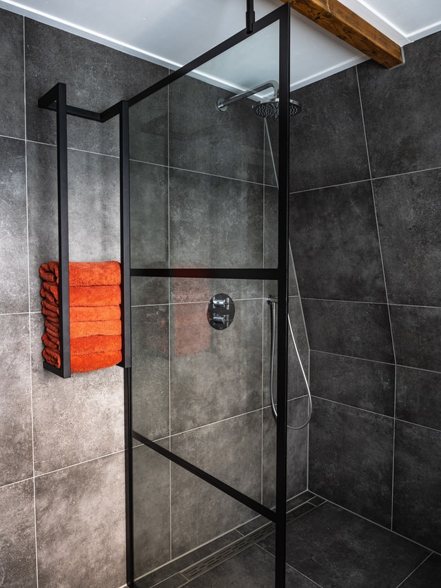 orange towels for gray bathroom