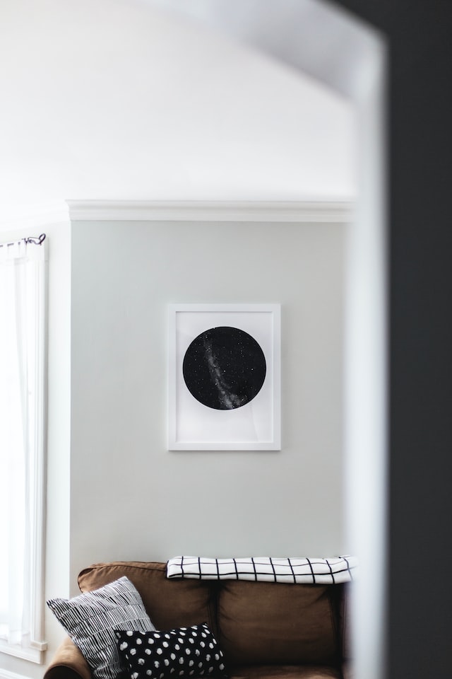 white picture frames against gray walls